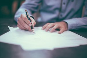 A Nepali mortgage broker in Sydney assisting with home loan document signing.